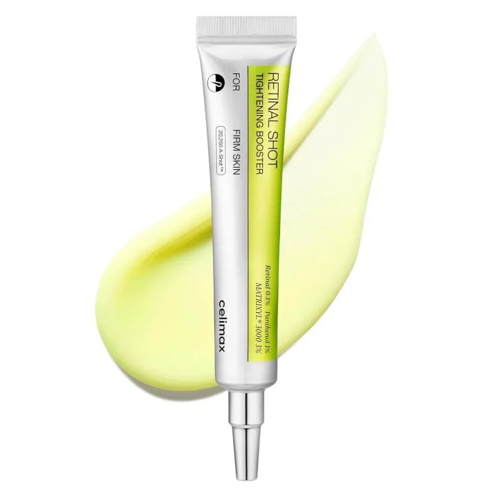 Skincare serum tube with a yellow smear on a white background